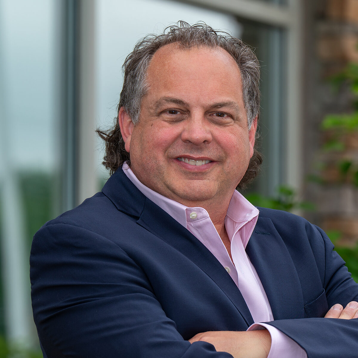 Dr. Todd J. Sheffler, smiling, in a professional suit, representing Caring Family Dentistry in Concord, showcasing commitment to patient care and cosmetic dentistry.